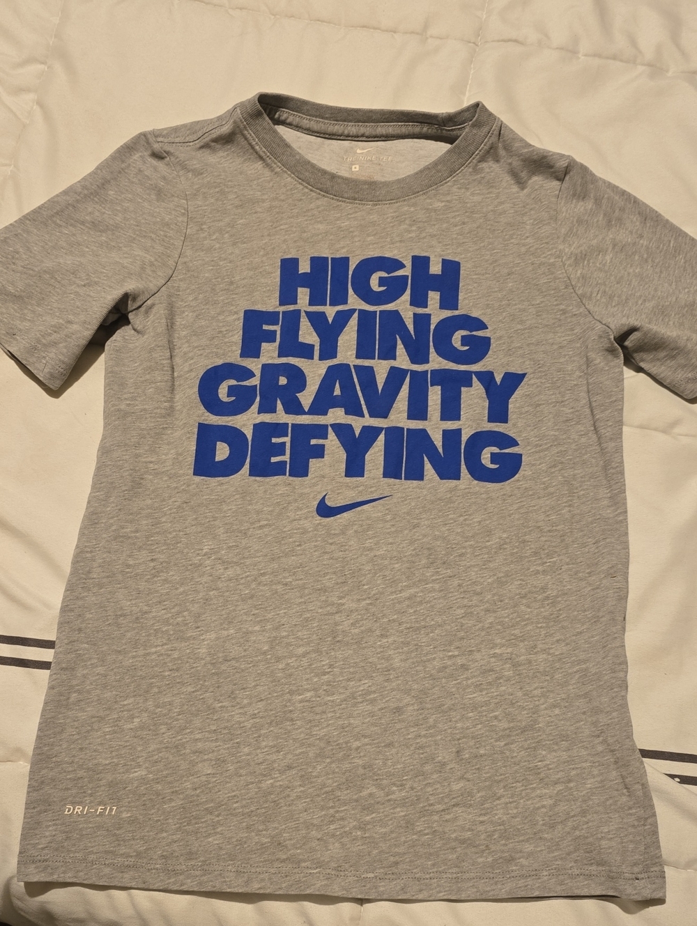 Nike Gray Tee with Blue 'High Flying Gravity Defying' Graphic
